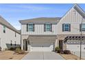 Stylish townhome featuring neutral siding, dark shutters and an attached garage at 2881 Grandin Way, Marietta, GA 30008