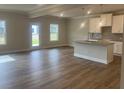 Bright living room with wood flooring and modern kitchen area at 4341 Portsbrook Ave, Snellville, GA 30039