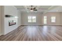 Bright and spacious living room featuring wood flooring, modern fireplace, and stylish coffered ceiling at 4341 Portsbrook Ave, Snellville, GA 30039