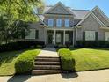 Inviting brick home showcasing a covered porch, well-maintained landscaping, and a welcoming entrance at 6163 Talmadge Nw Run, Acworth, GA 30101