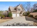 Beautiful brick home with a well-manicured lawn, two-car garage, and a long driveway at 6163 Talmadge Nw Run, Acworth, GA 30101