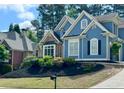 Inviting two-story home with blue exterior, tidy landscaping, and a convenient mailbox at 3390 Vista Creek Dr, Dacula, GA 30019