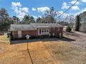 View of the back of a beautiful brick home with a backyard at 1891 Highway 81 E, Mcdonough, GA 30252