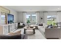 Open living area with large sectional sofa and plenty of natural light at 3152 Birdsong Ave, Covington, GA 30016