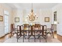 Elegant dining room featuring wainscoting, chandelier, and hardwood floors at 971 Saint Lyonn Cts, Marietta, GA 30068