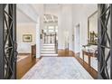 Grand foyer with hardwood floors, soaring ceilings, and elegant staircase at 971 Saint Lyonn Cts, Marietta, GA 30068