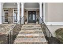 Inviting stone steps lead to the double front doors, framed by stone accents and white pillars at 971 Saint Lyonn Cts, Marietta, GA 30068