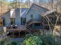 Back exterior showcasing a spacious deck and screened porch at 3391 Johnson Ferry Rd, Roswell, GA 30075