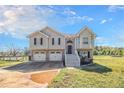 Charming two-story home with a two-car garage and steps leading to the front door under a blue sky at 1165 Hardin Bridge Rd, Euharlee, GA 30145