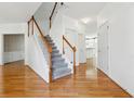Bright foyer with hardwood floors and a staircase leading to the upper level at 1464 Oglethorpe Dr, Suwanee, GA 30024