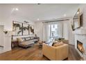 Cozy living room with hardwood floors, a brick fireplace, and comfortable seating next to lots of natural light at 3667 Peachtree Ne Rd # 16, Atlanta, GA 30319