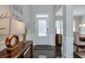 Bright entryway with hardwood floors, white door, and console table at 1868 Lakeview Bend Way, Buford, GA 30519