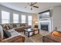 Spacious living room with fireplace, large sectional sofa, and flat-screen TV at 1868 Lakeview Bend Way, Buford, GA 30519