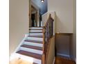 Elegant wooden staircase with wrought iron railings at 2969 Rivergreen Se Ln, Atlanta, GA 30339