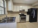 Small kitchen with stainless steel appliances and white cabinets at 3140 Shadow Walk Ln, Tucker, GA 30084
