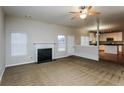 Open living room with kitchen views and fireplace at 5010 Mundy Dr, Cumming, GA 30028