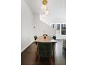 Elegant dining area featuring a modern light fixture, dark wood floors, and comfortable seating for four at 504 Rankin Ne St # 4, Atlanta, GA 30308