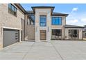A modern home with a grand entrance, two car garage and contemporary design, featuring a light brick exterior at 2753 Camp Branch Rd, Buford, GA 30519