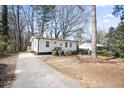 Quaint house with a long driveway and mature trees at 1084 Fairburn Nw Rd, Atlanta, GA 30331