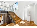 Modern staircase featuring wood treads, glass railings, and abundant natural light at 727 Berkeley Nw Ave, Atlanta, GA 30318