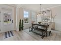 Formal dining room with a large table, bench seating, and plenty of natural light at 3850 Ivy Cottage Se Dr, Snellville, GA 30039