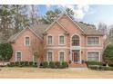 Brick home with a manicured lawn, decorative shrubbery, complemented by a front door with decorative glass at 5216 Old Mountain Ln, Powder Springs, GA 30127