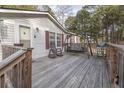 Wooden deck with rocking chairs, swing, and grill at 1050 Zion Church Rd, Dallas, GA 30157