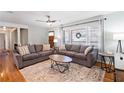 Spacious living room with hardwood floors, gray sofas, and a wood coffee table at 15 E Georgia Ave, Emerson, GA 30137