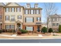 Charming two-story townhouse boasts brick and shake siding with manicured landscaping at 3869 Felton Hill Sw Rd, Smyrna, GA 30082