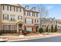 Two-story townhome featuring brick and shake siding, complemented by mature landscaping and a tidy yard at 3869 Felton Hill Sw Rd, Smyrna, GA 30082