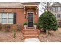 Welcoming front entrance features brick steps and potted plants for an added touch of charm at 3869 Felton Hill Sw Rd, Smyrna, GA 30082