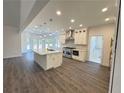 Spacious kitchen with stainless steel appliances, large island, custom cabinets, and modern fixtures at 9240 Prestwick Club Dr, Duluth, GA 30097