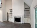 Living room showcasing a fireplace with marble surround, custom cabinets, and floating shelves at 9240 Prestwick Club Dr, Duluth, GA 30097
