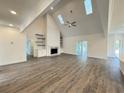 Bright living room featuring vaulted ceilings, wood floors, fireplace and open concept design at 9240 Prestwick Club Dr, Duluth, GA 30097