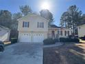 Tan house with double garage and large yard at 380 River Trace Dr, Villa Rica, GA 30180