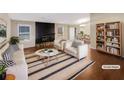Virtually staged living room features a fireplace and ample natural light at 4095 Maxanne Nw Dr, Kennesaw, GA 30144