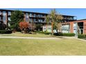 Well-maintained community grounds with lush green lawn, mature trees, and manicured landscaping at 5200 Peachtree Rd # 3221, Chamblee, GA 30341