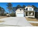 Two-story house with driveway and landscaped yard at 2308 Hanover Woods Rd, Lithonia, GA 30058