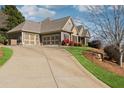Exterior view of home featuring a three-car garage and concrete driveway at 100 Pine Sandy Bank Dr, Canton, GA 30114