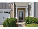 Close-up of the front door, showing the address, well-kept bushes, and partial garage door at 2657 Avanti Way, Decatur, GA 30035