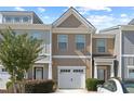 Inviting townhome showcases a one-car garage, attractive exterior, and tidy landscaping at 2657 Avanti Way, Decatur, GA 30035