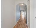 Hallway with wood floors, an archway leading to more rooms, and soft blue accent wall at 2657 Avanti Way, Decatur, GA 30035