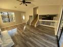 Inviting living room with wood floors, ceiling fan, and abundant natural light from a large window at 1126 Mainstreet Valley Dr, Stone Mountain, GA 30088