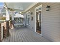 Inviting front porch featuring a porch swing, fan, and a stylish front door at 185 Elvan Ne Ave, Atlanta, GA 30317