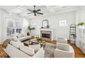 Light-filled living room with a fireplace, coffered ceiling, and large windows at 185 Elvan Ne Ave, Atlanta, GA 30317