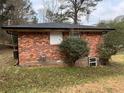 Brick exterior wall with a small bush and window at 126 Meadow Park Sw Ln, Atlanta, GA 30315