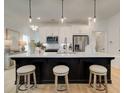Bright kitchen featuring a large island with seating and modern pendant lights, perfect for entertaining at 107 Winsome Way, Woodstock, GA 30188