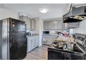 Galley kitchen with black appliances and granite countertops at 4646 Biffle Rd, Stone Mountain, GA 30088