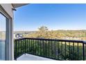 Scenic balcony view with black metal railings overlooking lush green trees at 1 Biscayne Nw Dr # 809, Atlanta, GA 30309