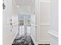 Hallway with black marble flooring and natural light beaming from the living room at 1 Biscayne Nw Dr # 809, Atlanta, GA 30309